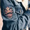 Lion dance patch on the arm of a jean jacket