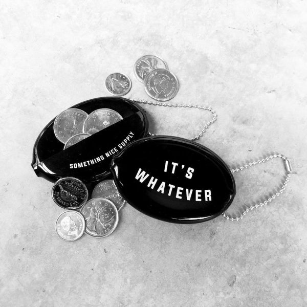 Two black rubber coin wallets. One shows the words "It's Whatever" on the front. The second one shows the back which says "Something Nice Supply" near the opening. There are a few coins around the pouch.